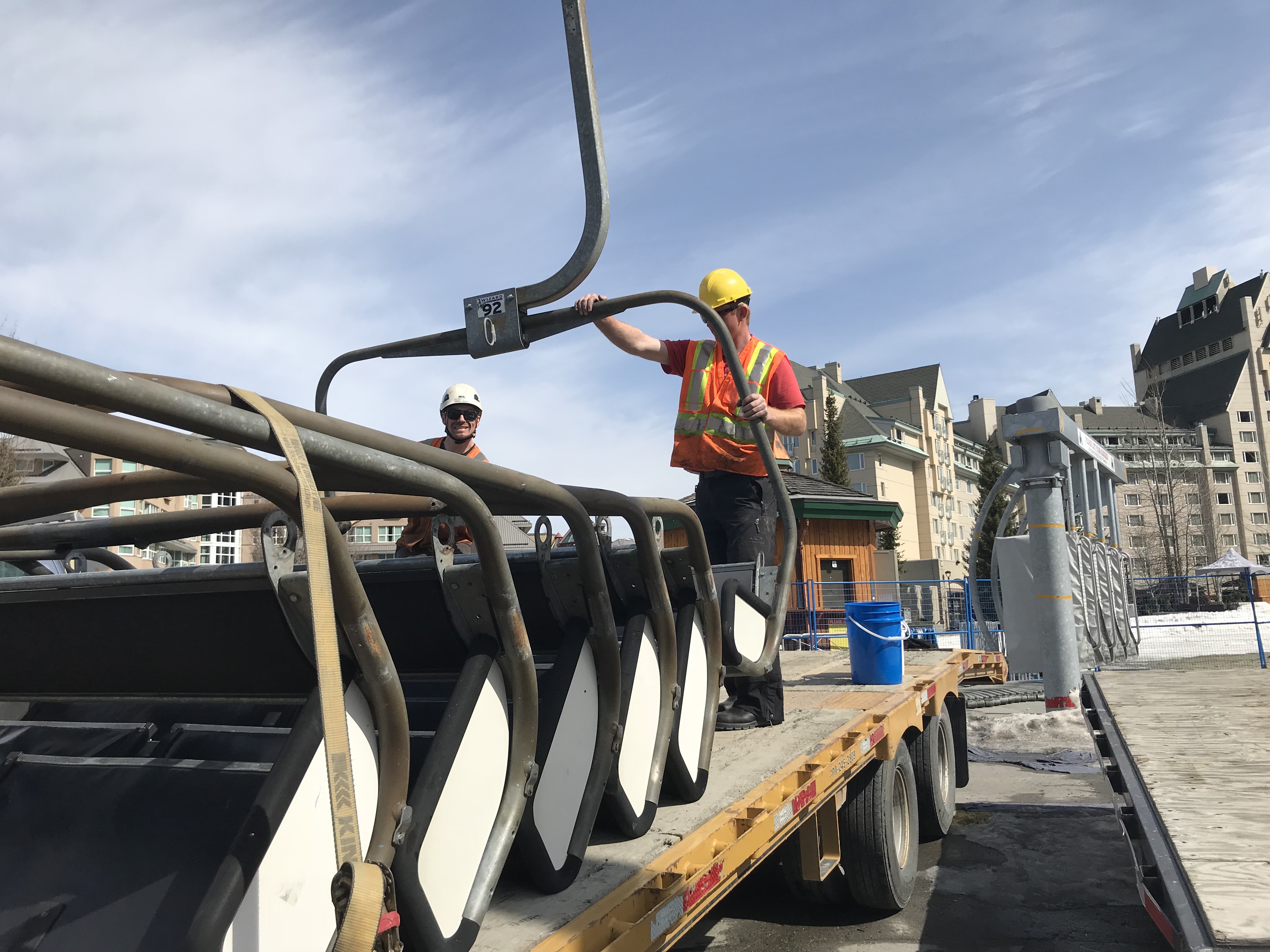 Workers loading chairs onto a truck