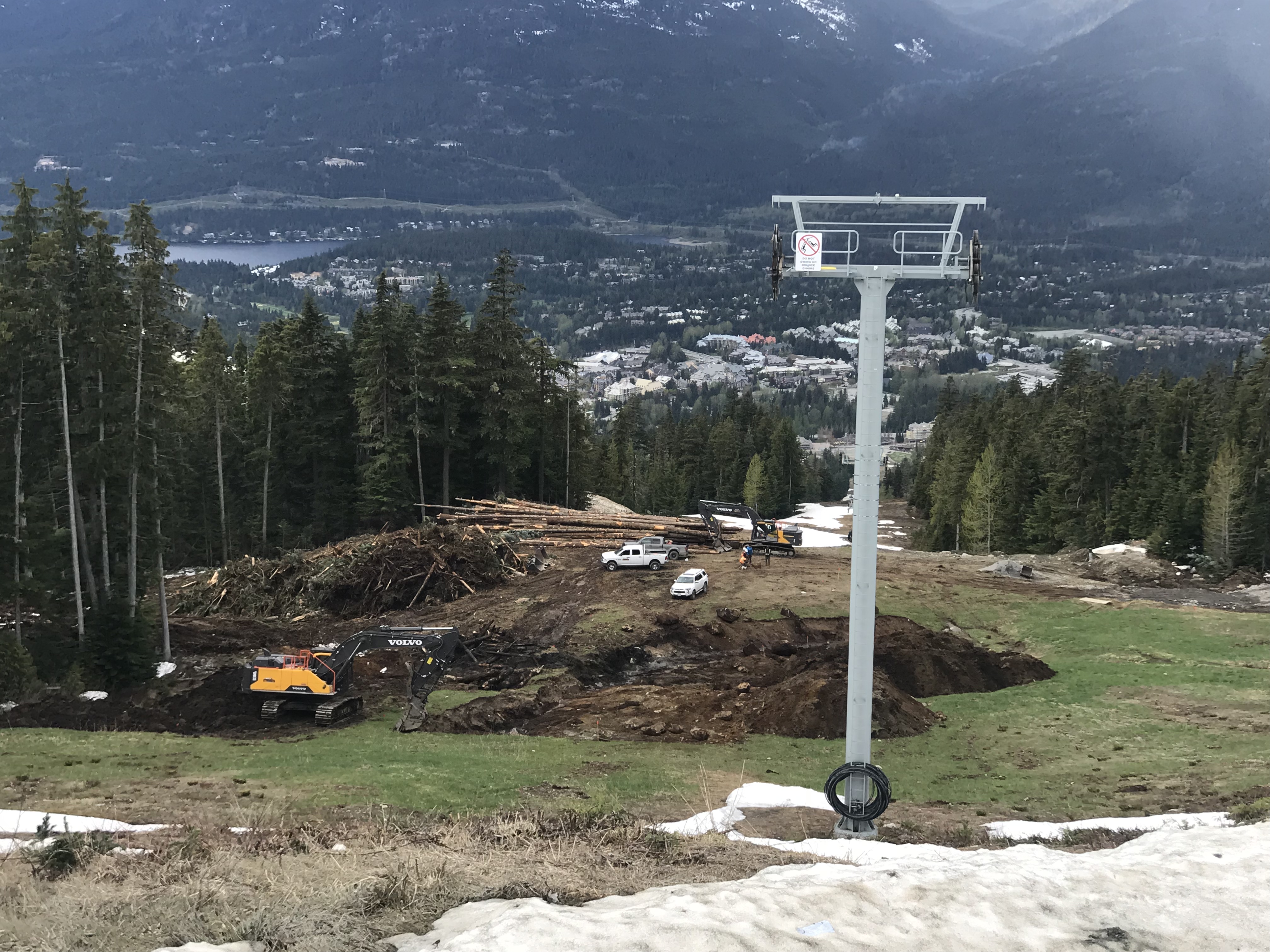 ground being cleared on ski slope with views of Whistler Village