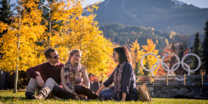 People enjoying Whistler village on sunny fall day.