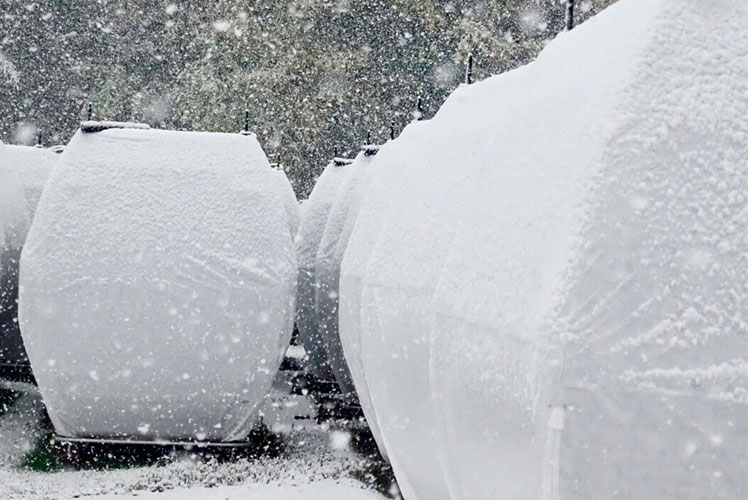 gondola cabins on the ground covered in snow